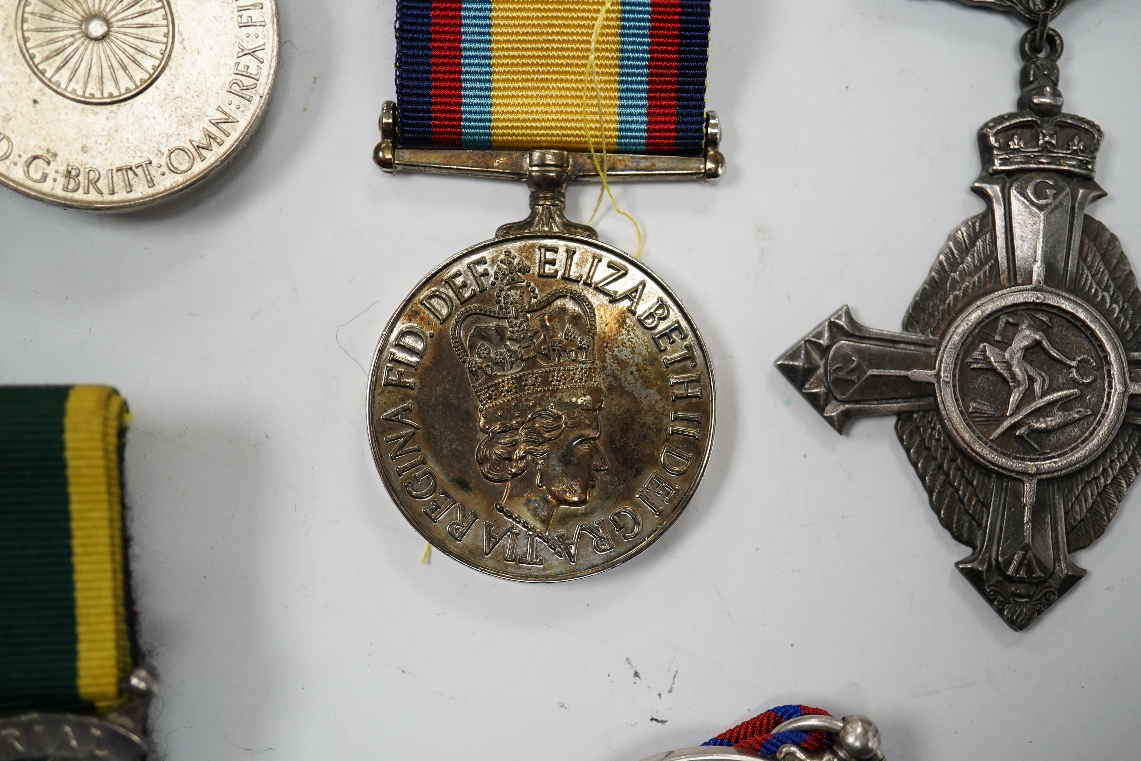 Twelve ERII and George VI medals, some medals arranged into two medals groups (containing unnamed medals and medals awarded to different recipients within the same group), including